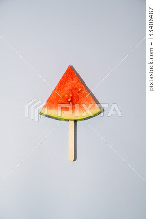 Watermelon triangle slice isolated on blue background Watermelon triangle slice isolated on blue background 133406487