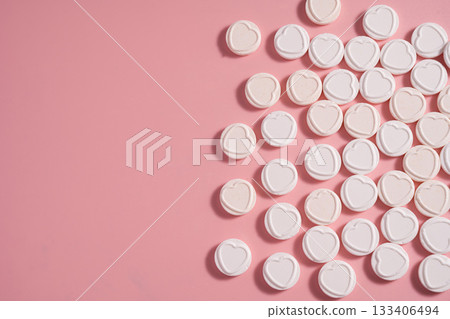 Heart-shaped candies over pink background, abstract food love background, copy space Heart-shaped candies over pink background, abstract food love background, copy space 133406494
