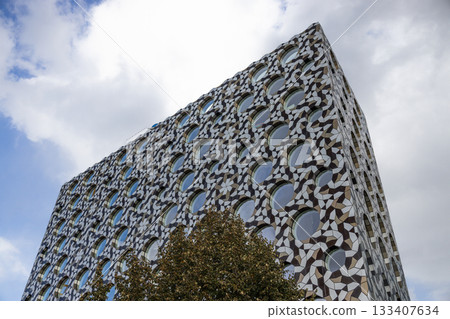 Parametric geometric facade on contemporary building, low angle urban architecture 133407634