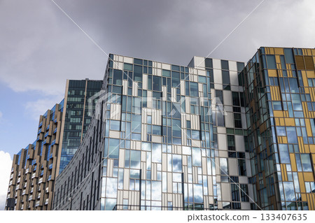 Geometric glass facade of modern office towers with reflective windows Geometric glass facade of modern office towers with reflective windows 133407635