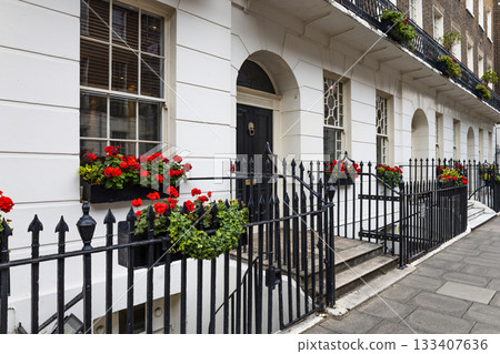 Elegant Georgian terrace in London with flowered windows and wrought iron railings 133407636