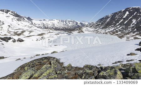 Snow-covered landscape at Leirvassbu, Leirdalen in Jotunheimen National Park captures winter's serene beauty 133409069