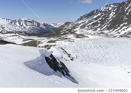Snowy landscape showcases the beauty of Leirvassbu in Leirdalen during spring in Jotunheimen National Park 133409081