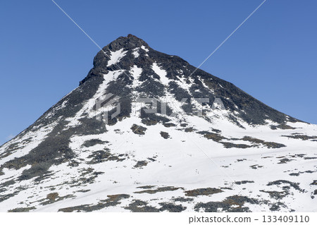 Snow-covered Kykja mountain and bright blue sky at Leirvassbu in Jotunheimen National Park during spring season 133409110