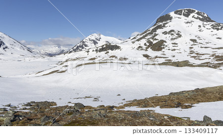 Snow-covered landscape at Leirvassbu in Leirdalen during clear weather in Jotunheimen National Park in Norway 133409117