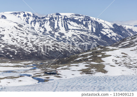 Snowy landscape in Leirvassbu, Leirdalen within Jotunheimen National Park showcases winter beauty and rugged terrain Snowy landscape in Leirvassbu, Leirdalen within Jotunheimen National Park showcases winter beauty and rugged terrain 133409123