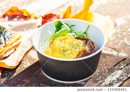 Loco moco rice bowl eaten outdoors 133409461