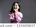 Young woman speaking with a microphone 133409837