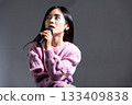 Young woman speaking with a microphone 133409838