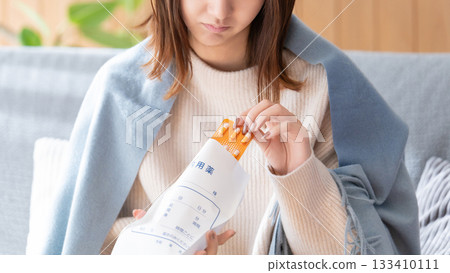 Unwell woman taking medicine Unwell woman taking medicine 133410111
