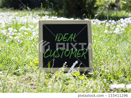 Ideal Customer symbol. Concept word Ideal Customer on chalk blackboard. Beautiful meadow background. Business and Ideal Customer concept. Copy space. Ideal Customer symbol. Concept word Ideal Customer on chalk blackboard. Beautiful meadow background. Business and Ideal Customer concept. Copy space. 133411296
