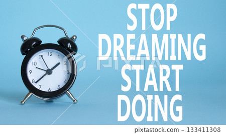 Stop Dreaming Start Doing symbol. Beautiful blue background with alarm clock. Business and Stop Dreaming Start Doing concept. Copy space. Stop Dreaming Start Doing symbol. Beautiful blue background with alarm clock. Business and Stop Dreaming Start Doing concept. Copy space. 133411308