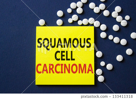 Squamous Cell Carcinoma symbol. Concept words Squamous Cell Carcinoma on yellow note. Beautiful deep blue background with pills. Healthcare and Squamous Cell Carcinoma concept. Copy space. 133411318
