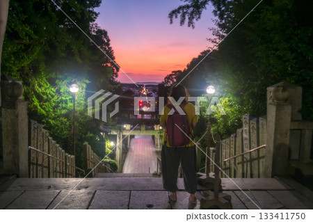 Tourist view torii gate and city from Miyajidake temple at dusk, Fukuoka 133411750