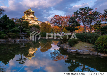 Osaka castle by autumn foliage garden with reflection on pond, Kansai Osaka castle by autumn foliage garden with reflection on pond, Kansai 133411764
