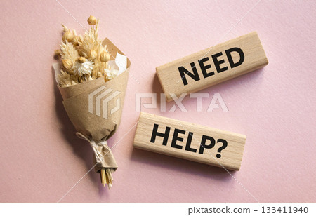 Need Help symbol. Concept word Need Help on wooden blocks. Beautiful pink background with bouquet of flowers. Business and Need Help concept. Copy space Need Help symbol. Concept word Need Help on wooden blocks. Beautiful pink background with bouquet of flowers. Business and Need Help concept. Copy space 133411940
