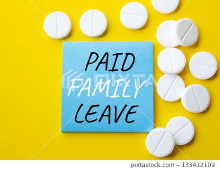 Paid Family Leave symbol. Concept words Paid Family Leave on blue note. Beautiful yellow background with pills. Healthcare and Paid Family Leave concept. Copy space. 133412109
