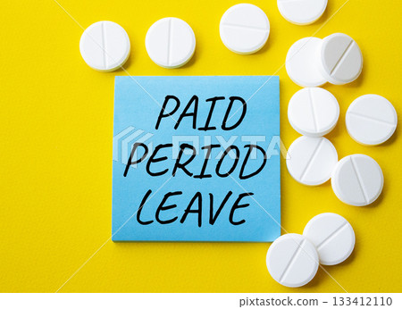 Paid Period Leave symbol. Concept words Paid Period Leave on blue note. Beautiful yellow background with pills. Healthcare and Paid Period Leave concept. Copy space. 133412110