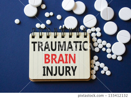 Traumatic Brain Injury symbol. Concept words Traumatic Brain Injury on notebook. Beautiful deep blue low background with pills. Healthcare and Traumatic Brain Injury concept. Copy space. Traumatic Brain Injury symbol. Concept words Traumatic Brain Injury on notebook. Beautiful deep blue low background with pills. Healthcare and Traumatic Brain Injury concept. Copy space. 133412132