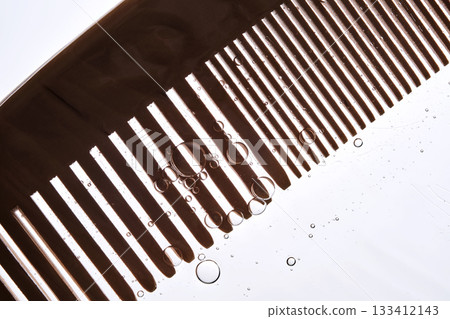A comb with hair serum. The photo shows the texture of the cosmetic product. 133412143