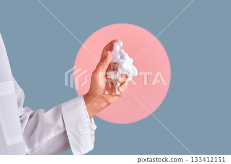 Hand holding foaming cleanser bottle skincare routine 133412151