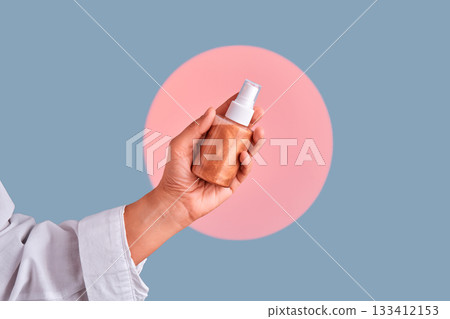 Hand holding body shimmer spray bottle mockup Hand holding body shimmer spray bottle mockup 133412153