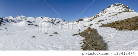 Spectacular panorama of a snowy landscape at Leirvassbu in Jotunheimen National Park during springtime in Norway 133412474