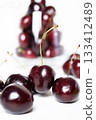 Sweet ripe cherries in  glass bowl around white background 133412489