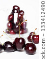 Sweet ripe cherries in  glass bowl around white background 133412490