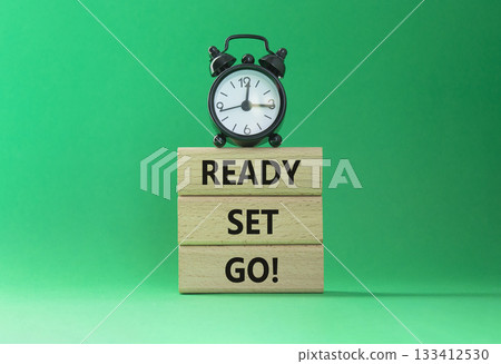 Ready Set Go symbol. Concept words Ready Set Go on wooden blocks. Beautiful green background with alarm clock. Business and Ready Set Go concept. Copy space. Ready Set Go symbol. Concept words Ready Set Go on wooden blocks. Beautiful green background with alarm clock. Business and Ready Set Go concept. Copy space. 133412530
