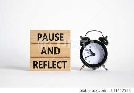 Pause and Reflect symbol. Concept words Pause and Reflect on wooden blocks. Beautiful white background with alarm clock. Business and Pause and Reflect concept. Copy space. 133412534
