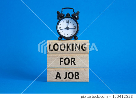 Looking for a job symbol. Concept words Looking for a job on wooden blocks. Beautiful blue background with alarm clock. Business and Looking for a job concept. Copy space. Looking for a job symbol. Concept words Looking for a job on wooden blocks. Beautiful blue background with alarm clock. Business and Looking for a job concept. Copy space. 133412538