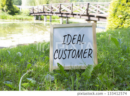 Ideal Customer symbol. Concept word Ideal Customer on white chalk blackboard. Beautiful meadow background with bridge. Business and Ideal Customer concept. Copy space. Ideal Customer symbol. Concept word Ideal Customer on white chalk blackboard. Beautiful meadow background with bridge. Business and Ideal Customer concept. Copy space. 133412574