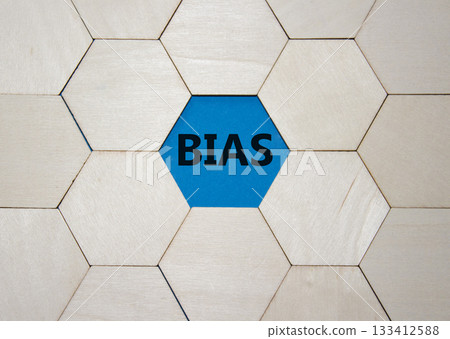 Bias symbol. Concept word Bias on wooden comb puzzle. Beautiful blue background. Business and Bias concept. Copy space. Bias symbol. Concept word Bias on wooden comb puzzle. Beautiful blue background. Business and Bias concept. Copy space. 133412588