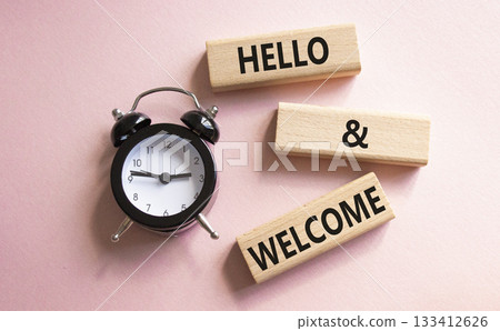Hello and Welcome symbol. Concept words Hello and Welcome on wooden blocks. Beautiful pink background with alarm clock. Business and Hello and Welcome concept. Copy space. Hello and Welcome symbol. Concept words Hello and Welcome on wooden blocks. Beautiful pink background with alarm clock. Business and Hello and Welcome concept. Copy space. 133412626