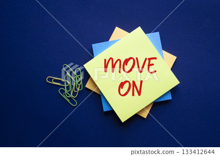 Move on symbol. Yellow sticky note with words Move on. Beautiful deep blue background. Business and Move on concept. Copy space. Move on symbol. Yellow sticky note with words Move on. Beautiful deep blue background. Business and Move on concept. Copy space. 133412644