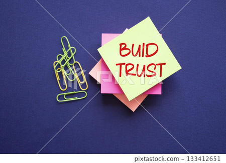 Build trust symbol. Build trust on sticky note. Beautiful deep blue background. Business and Build trust concept. Copy space. Build trust symbol. Build trust on sticky note. Beautiful deep blue background. Business and Build trust concept. Copy space. 133412651
