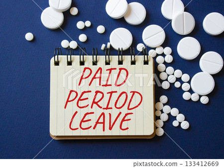 Paid Period Leave symbol. Concept words Paid Period Leave on notebook. Beautiful deep blue background with pills. Healthcare and Paid Period Leave concept. Copy space. Paid Period Leave symbol. Concept words Paid Period Leave on notebook. Beautiful deep blue background with pills. Healthcare and Paid Period Leave concept. Copy space. 133412669