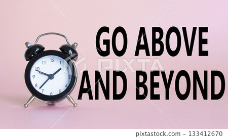 Go above and beyond symbol. Beautiful pink background with alarm clock. Business and Go above and beyond concept. Copy space. 133412670
