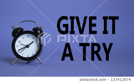 Give it a try symbol. Beautiful purple background with alarm clock. Business and Give it a try concept. Copy space. Give it a try symbol. Beautiful purple background with alarm clock. Business and Give it a try concept. Copy space. 133412674
