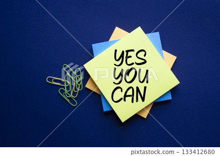 Yes You Can symbol. Concept words Yes You Can on white sticky notes. Beautiful deep blue background. Business and Yes You Can concept. Copy space. Yes You Can symbol. Concept words Yes You Can on white sticky notes. Beautiful deep blue background. Business and Yes You Can concept. Copy space. 133412680