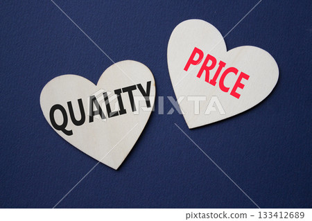 Price or Quality symbol. Concept word Price or Quality on wooden hearts. Beautiful deep blue background. Business and Price or Quality concept. Copy space 133412689