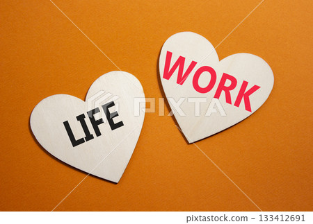 Life or Work symbol. Concept word Life or Work on wooden hearts. Beautiful orange background. Business and Life or Work concept. Copy space Life or Work symbol. Concept word Life or Work on wooden hearts. Beautiful orange background. Business and Life or Work concept. Copy space 133412691