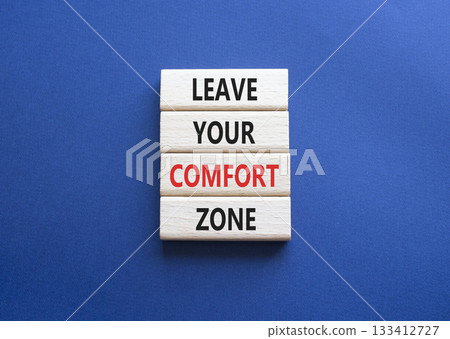 Comfort Zone symbol. Wooden blocks with words Leave your Comfort Zone. Beautiful deep blue background. Business and Comfort Zone concept. Copy space. 133412727