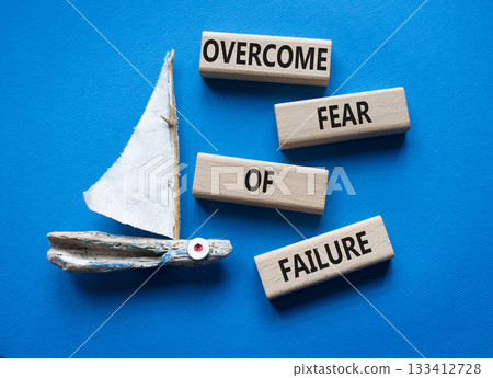 Fear of failure symbol. Concept words Overcome Fear of failure on wooden blocks. Beautiful blue background with boat. Business and Fear of failure concept. Copy space. 133412728