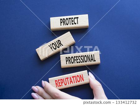 Professional Reputation symbol. Concept words Protect Your Professional Reputation on wooden blocks. Beautiful deep blue background. Businessman hand. Business concept. Copy space Professional Reputation symbol. Concept words Protect Your Professional Reputation on wooden blocks. Beautiful deep blue background. Businessman hand. Business concept. Copy space 133412732