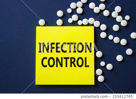 Infection Control symbol. Concept word Infection Control on yellow note. Beautiful deep blue background with pills. Medicine and Infection Control concept. Copy space 133412745