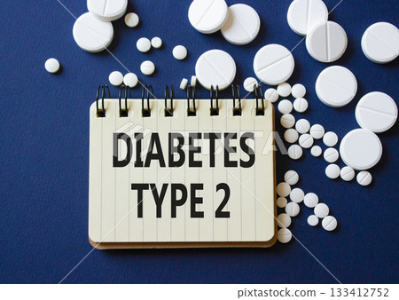 Diabetes Type 2 symbol. Concept word Diabetes Type 2 on notebook. Beautiful deep blue background with pills. Medicine and Diabetes Type 2 concept. Copy space Diabetes Type 2 symbol. Concept word Diabetes Type 2 on notebook. Beautiful deep blue background with pills. Medicine and Diabetes Type 2 concept. Copy space 133412752