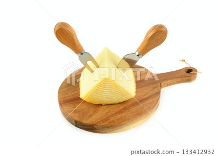 Wedge of Cheese and Knives on a Wooden Board Isolated on White Wedge of Cheese and Knives on a Wooden Board Isolated on White 133412932