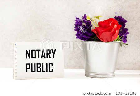 There is a notebook on the table with the inscription NOTARY PUBLIC 133413195
